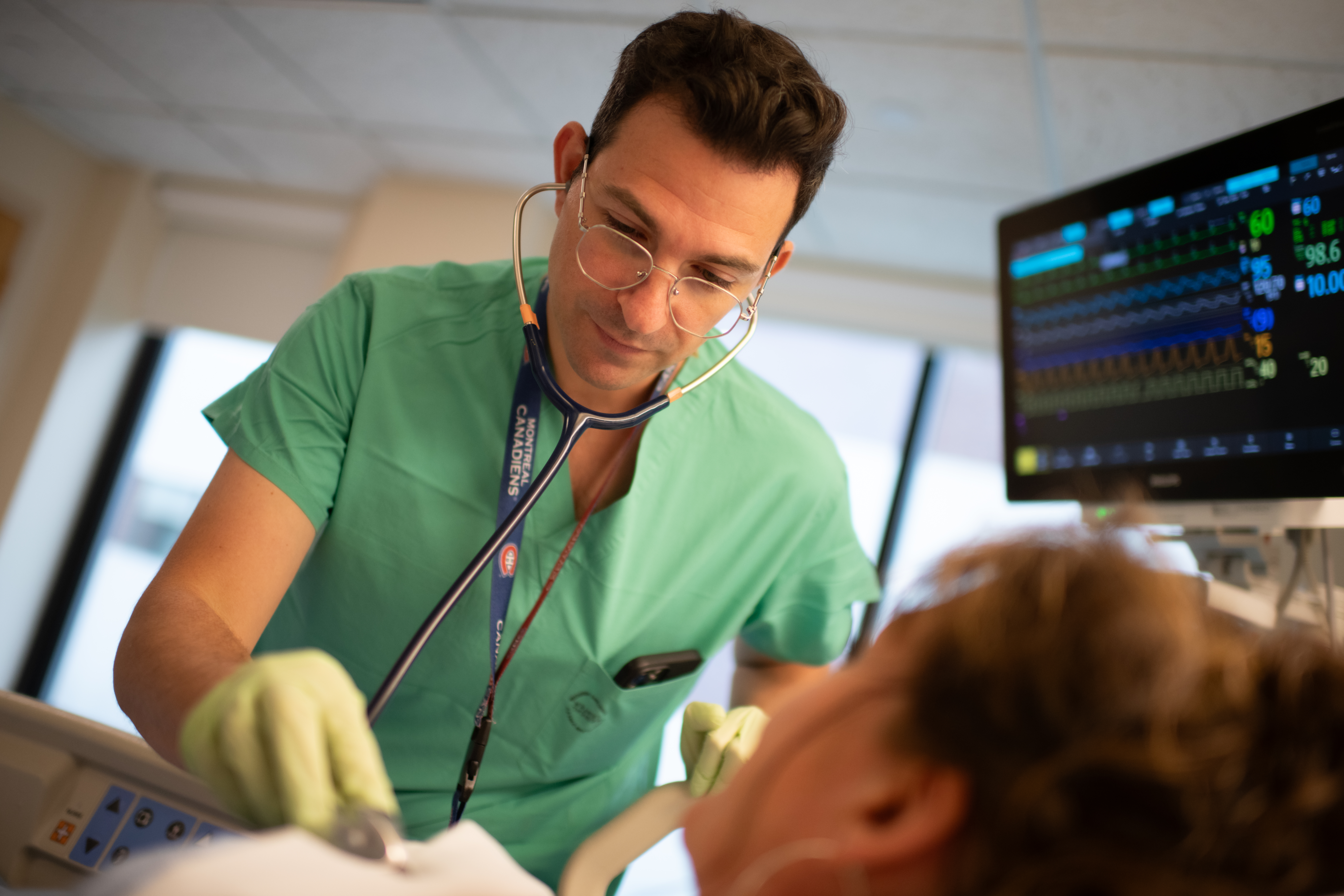 A Champlain Valley Physicians Hospital provider listens to a patients heart in the Intensive Care Unit.