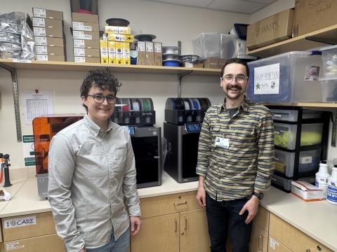 Laura Mulvey, MD and Miles Lamberson pose in front of 3d printers at UVM Medical Center