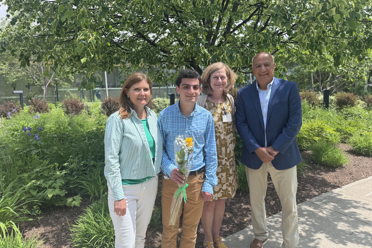 Bijan Salimi poses with family and Jill Bowen, PhD