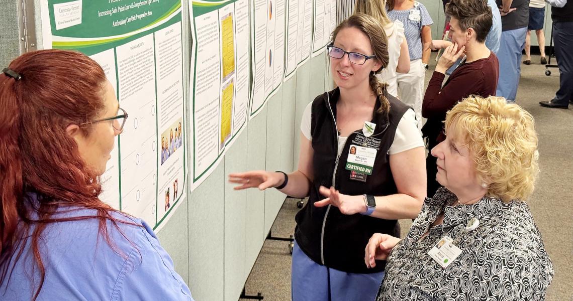Staff at Central Vermont Medical Center talk with hospital president and chief operating officer Anna Noonan.