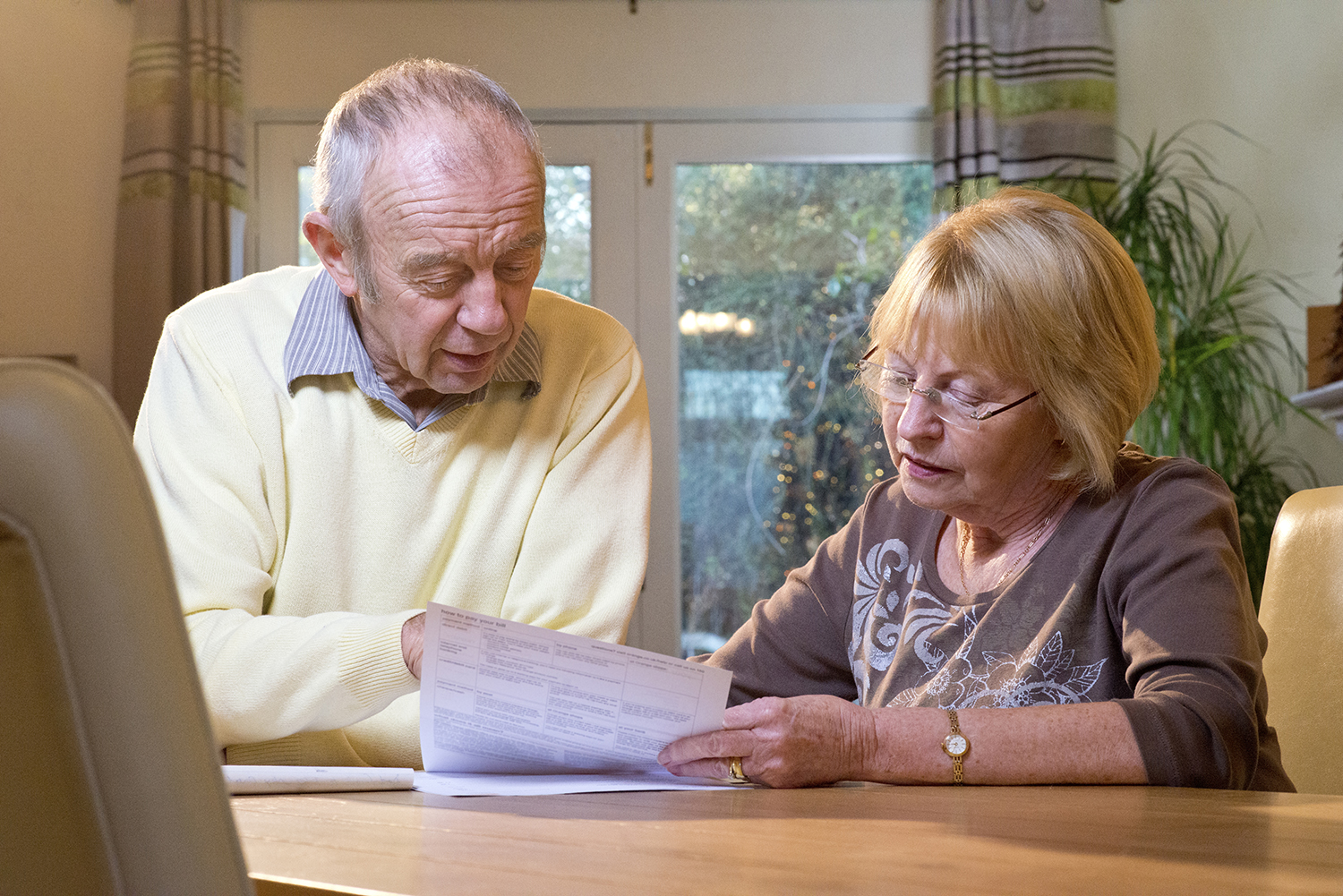 An older couple reviewing paper documents