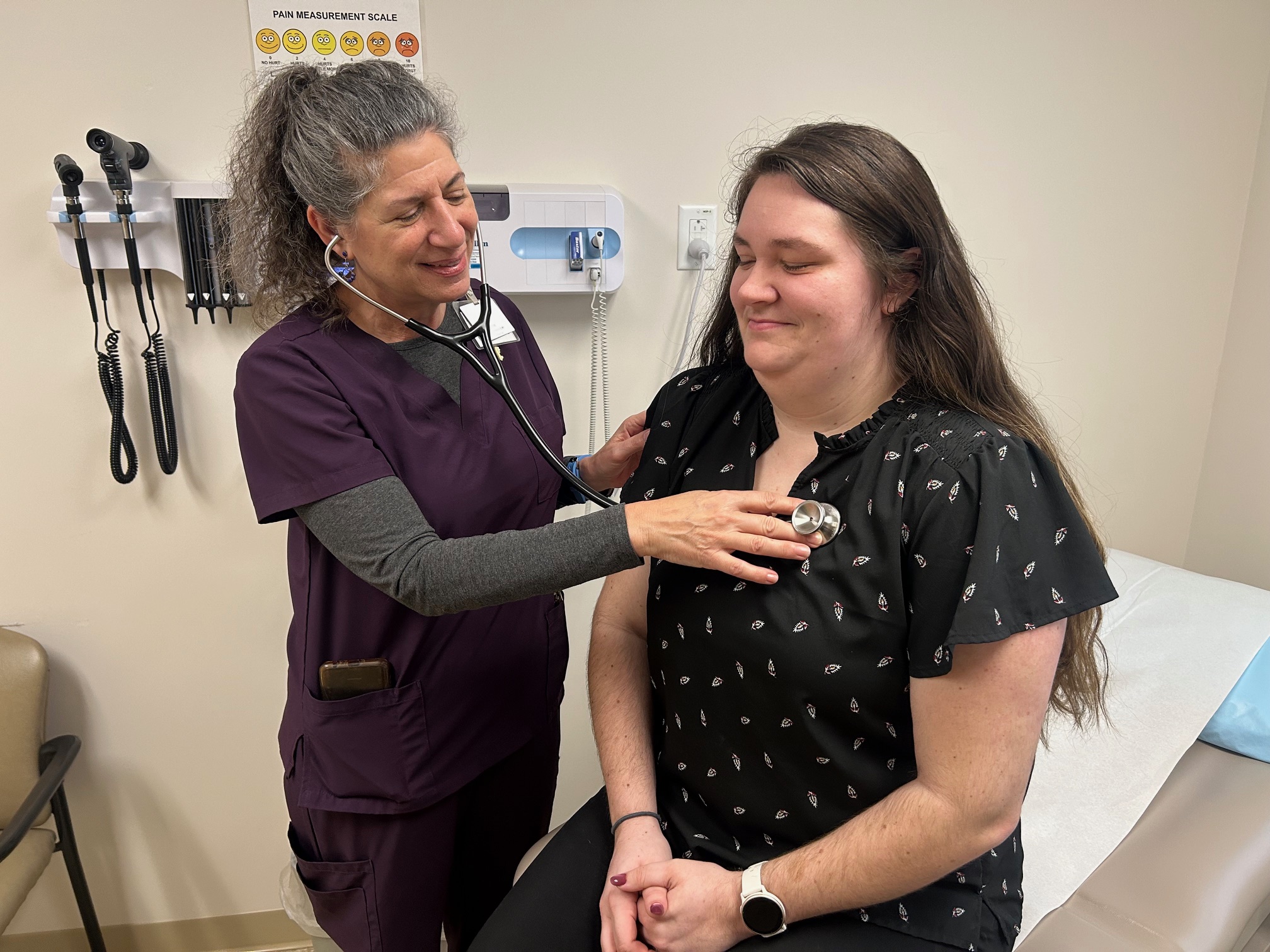 A medical provider checks a patient's heartbeat.