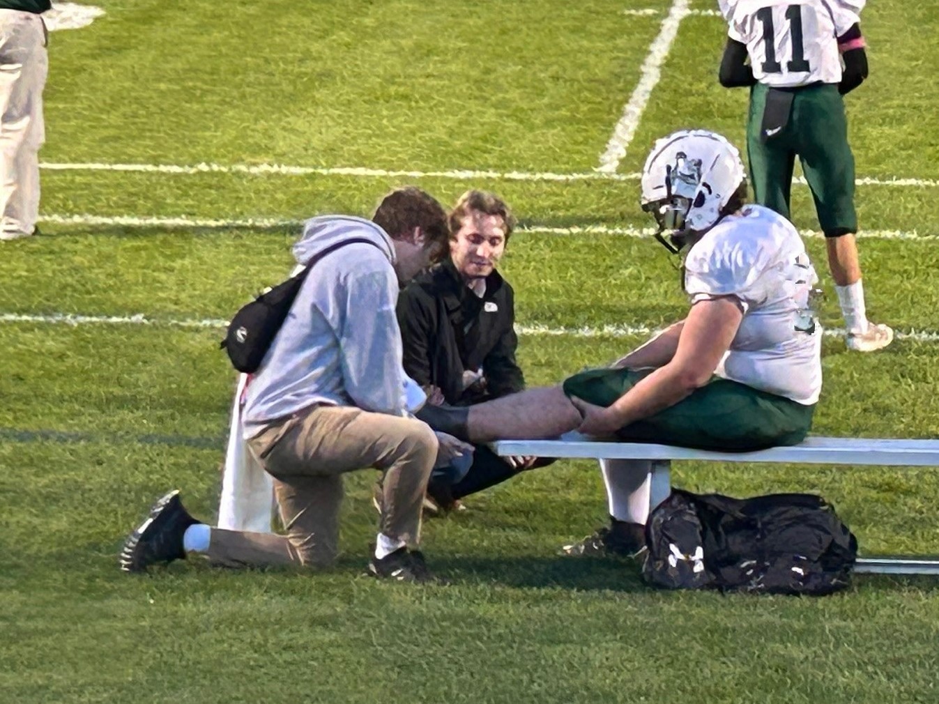 GME Family Medicine resident working on football player's ankle