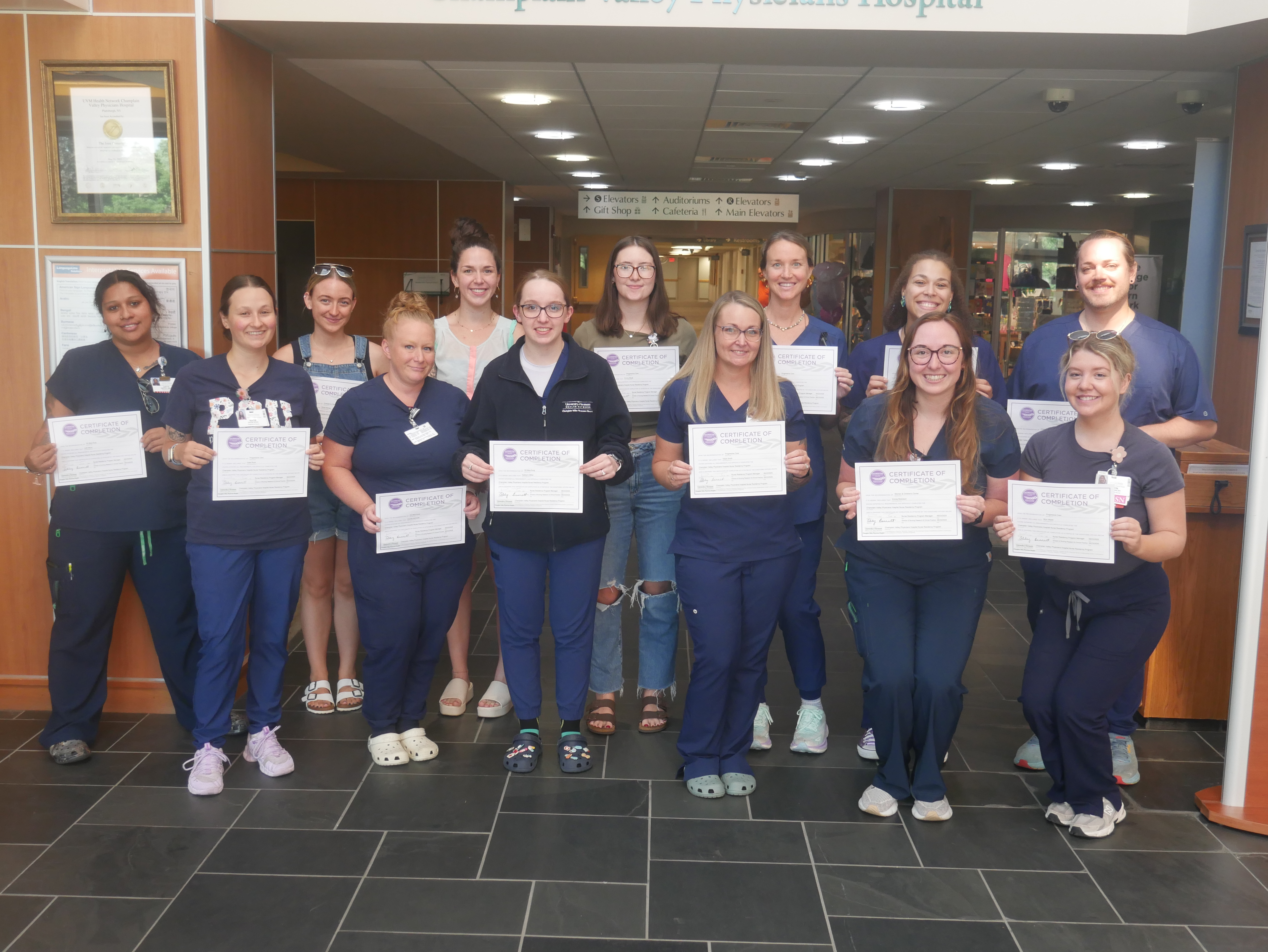 A group of nurse residency grads poses with their certificates.