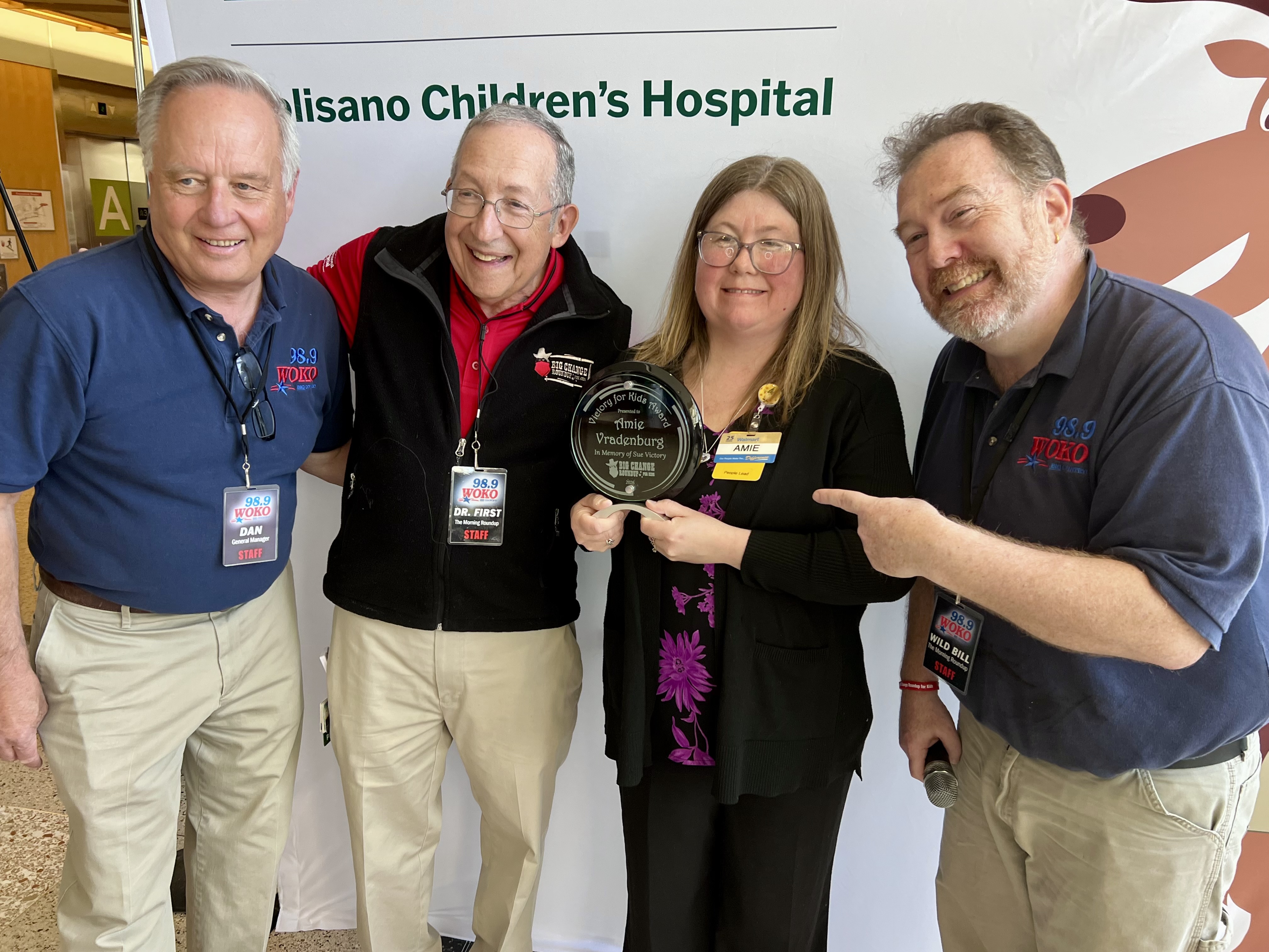 Amie Vradenburg (second from right) receive the inaugural Victory for Kids Award from Dan Dubbonnet, general manager of WOKO (far left), Dr. Lewis First, MD, chair of Pediatrics at Golisano Children’s Hospital at UVM Health (second from left), and “Wild Bill” Sargent of WOKO (far right).