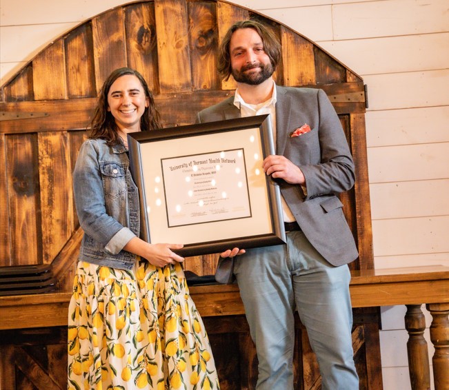 CVPH Family Medicine Residency Faculty member Delaney Osborn, MD, left, presents graduate Nicholas Rzepski, MD with his certificate of completion at the Residency’s commencement ceremony held June 19 at the Rainbow Banquet Hall, Altona. Dr. Rzepski, who has joined Hudson Health Headwaters, was one of seven graduates celebrated at the event. 