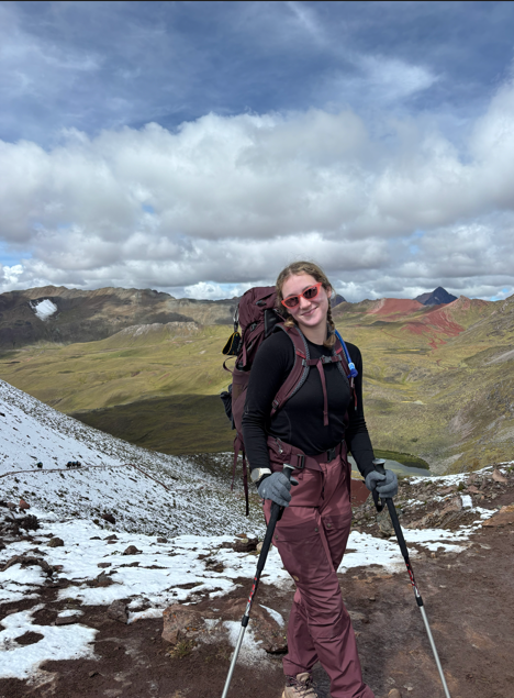 Lillian Brouwer, MD wearing a backpack and holding treking poles the mountains