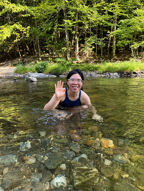 Terisa Yiin, MD partially submerged in a river