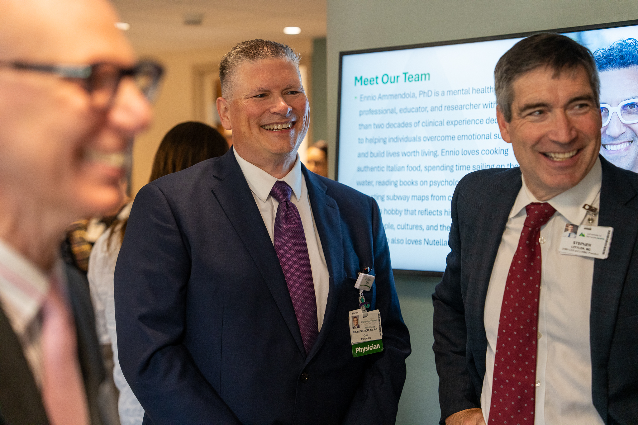 Dr. Leffler and Dr. Althoff stand smiling with others at the clinic opening. 
