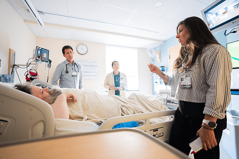 Social Worker consults with patient in bed
