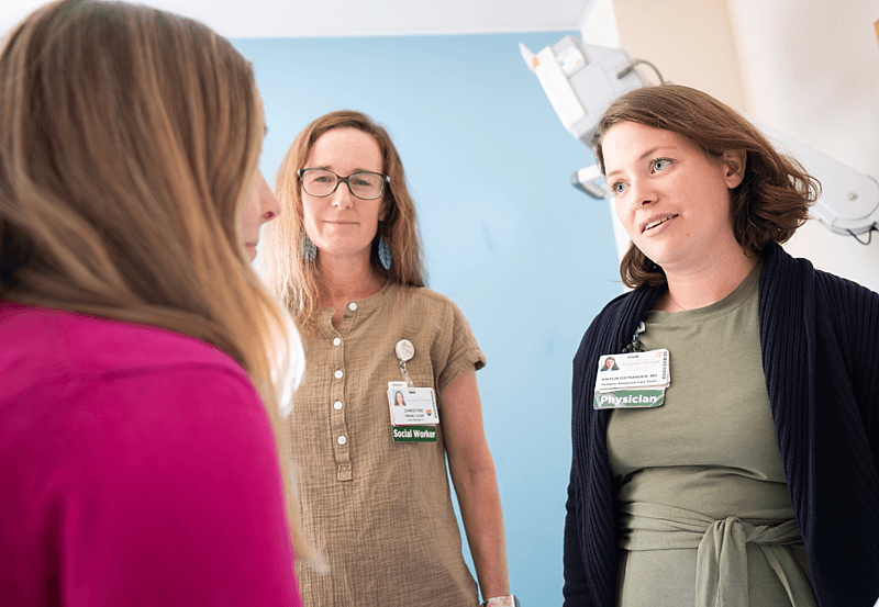 Physician and Social Worker consult with pediatric patient