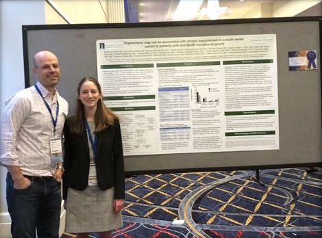 Catherine Clifford, MD standing in front of her presentation. 