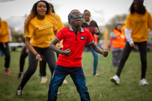 Children dancing in field