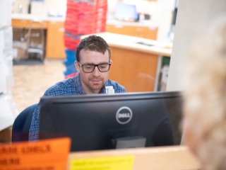 A pharmacist looks at computer.