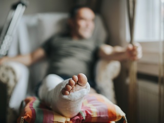 A patient props up their injured foot.