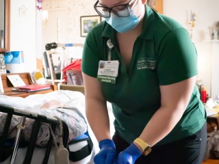 A medical professional sterilizes equipment in a patient home.