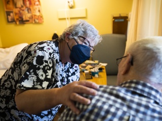 A nurse speaks with a resident.