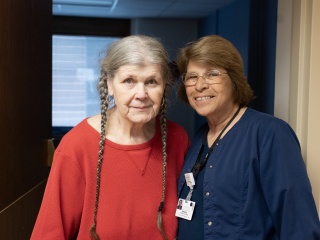 A medical provider and a resident pose for a photo.