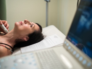 Close-up of a patient receiving an ultrasound of their thyroid.