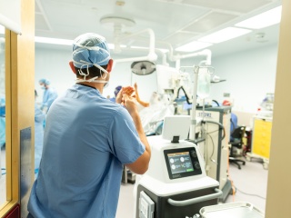 A surgeon walks in to an operating room.