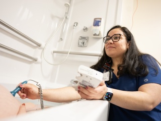 A Champlain Valley Physicians Hospital nurse listens to the heartbeat of a baby during a water birth at the Alice T. Miner Women & Childrens Center.