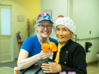 Two women smile at the camera.