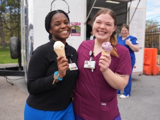 Employees at UVM Medical Center holding free ice cream cones.