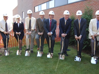 Group of individuals hold shovels outside of central vermont medical center for a groundbreaking ceremony.
