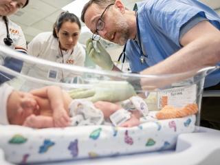 A Champlain Valley Physician Hospital provider examines a newborn.