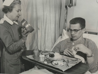 Historical photo of patient with meal at Porter Medical Center.