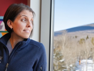 Rebecca Bell, MD, looks out a window from her office.