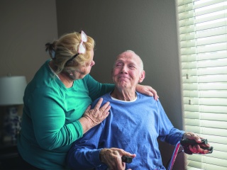 Two adults comfort each other.