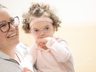 Pediatric patient Nora McDougall and her mother smile for a photo.