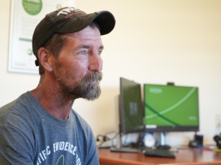 Aaron Blair sits in an office.