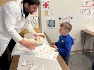 A doctor speaks to a pediatric patient.