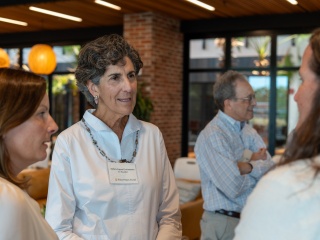 Deborah Lopez Gottesman, co-founder of Four Pines Fund, speaks to a group at an event.