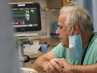 Mike Kiernan, MD, speaks to one of his patients in the Emergency Department at Porter Medical Center.