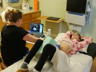 Pediatric patient Macie Hoyt lays on a hospital bed for an ultrasound on her abdomen.