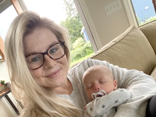 Sage Collins poses for a photo with her infant son. 