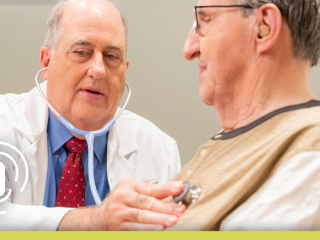 David Schneider, MD, examines a patient with a stethoscope.