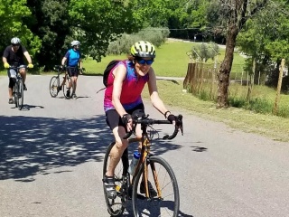 Dorsey Naylor rides her bike on a bike path.