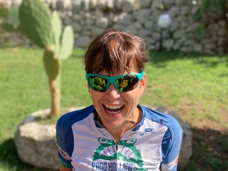 Portrait of Keele Kozak wearing biking clothing outside.