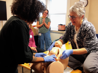Midwives learn childbirth techniques using medical dummies.