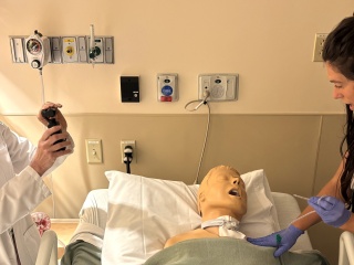 Nancy Malhotra, Stroke Nurse Practitioner and Lindsey Willis, Nursing Professional Development Practitioner, filming a caretaker training video at UVM Medical Center.
