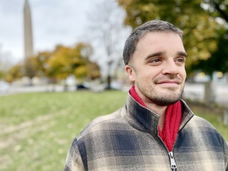Portrait of Jonah Curtin standing outside.