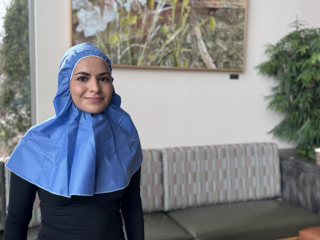 A patient wears a disposable hijab.