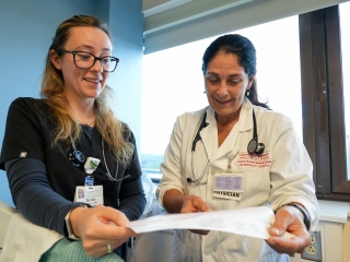 Central Vermont Medical Center doctor and nurse review a patient's chart in the exam room.