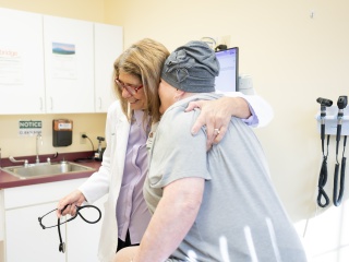 A medical provider hugs a patient.