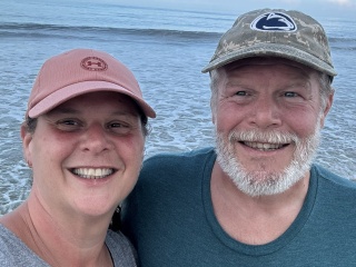 Mike and Kate Spaeder pose for a photo by the lake.