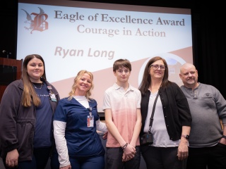 Kaylee Miller, RN, and Linda Dumbuya, RN, both emergency department nurses at Champlain Valley Physicians Hospital, with Ryan Long, 14, and his grandparents, Michelle and Charlie Hunt during a ceremony at Beekmantown Middle School.